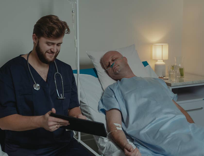 PACU nurse updates the patient's record in the recovery room.