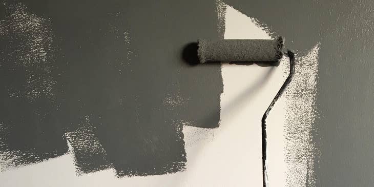 Painter painting a wall with a roller