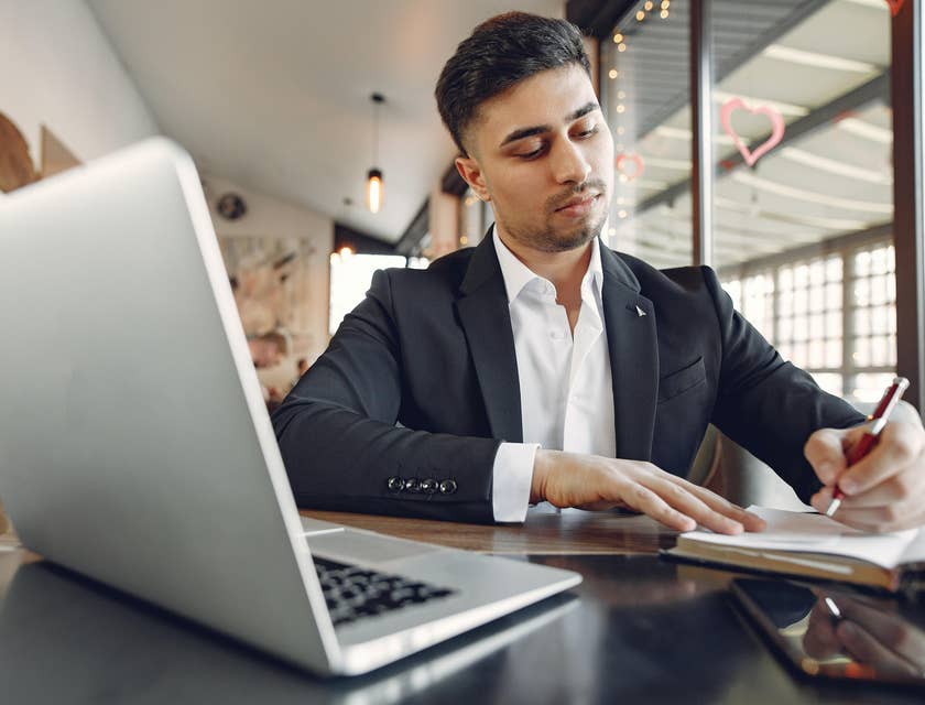 A paralegal working in front of a laptop preparing some legal documents requested by attorney.