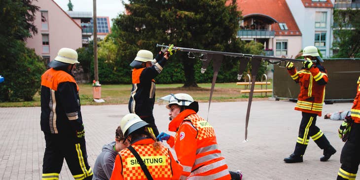 Paramedic team practice on how to use first aid as they practice safety drills outdoors.