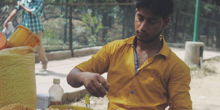 A man doing part-time work at a market.