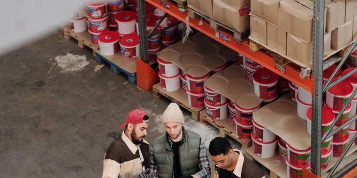 Parts manager with workers checking the inventory level. for replenishment.