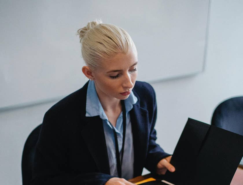 Payroll manager checks the documentation of payroll data during a meeting.