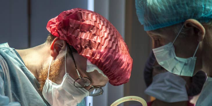 Pediatric Surgeon carefully operating on a young patient with his assistant