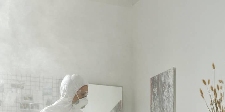 Pest control technician working in a residential building.