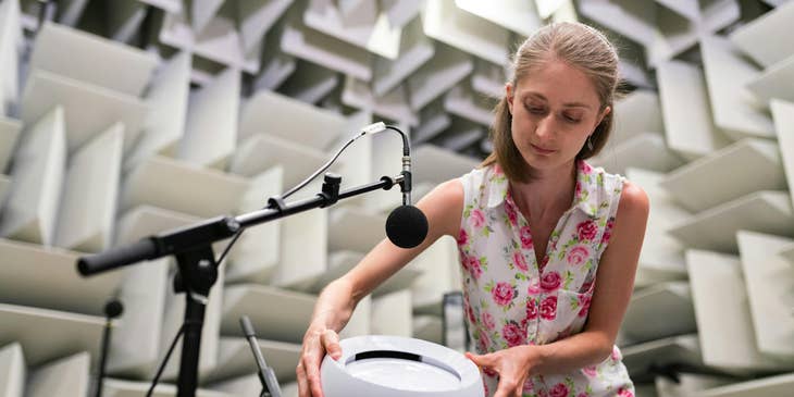 An engineer testing a new product in a soundproof room.