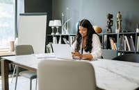 A woman composing a thank-you email after a phone interview.