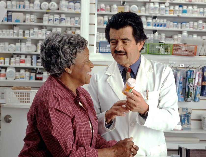 Pharmacy manager assist customer in getting the right medication.