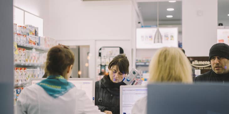 Pharmacy technician accepts written prescription from patients over the counter.