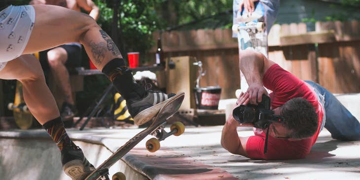 Photographer doing anything just to capture the best shot of a skater doing tricks.