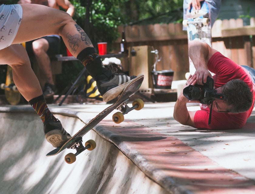 Photographer doing anything just to capture the best shot of a skater doing tricks.