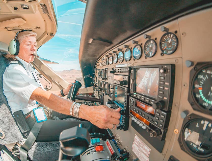 Pilot checking and setting the instruments and radios before taking off.