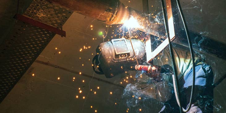 Pipe fitter installing a pipe system in  abuilding