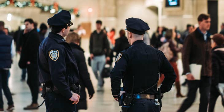 Two police officers patrolling grand central terminal and ensuring peace and order is being maintained.