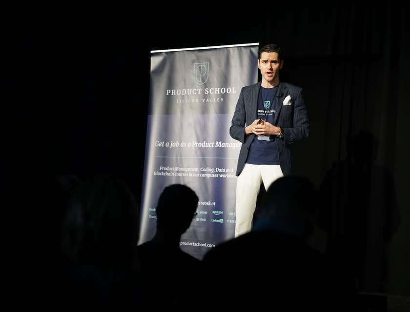 Presenter talking to the audience during a conference about IT related courses.