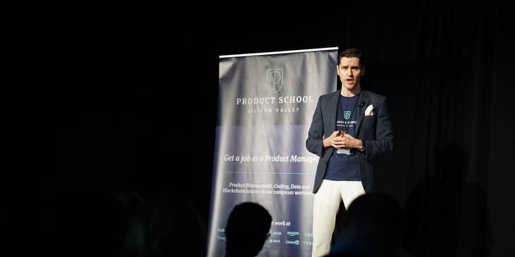 Presenter talking to the audience during a conference about IT related courses