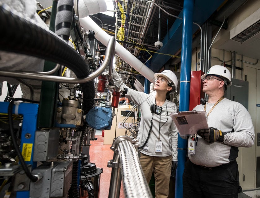 Process control engineer checking the machinery with a technician at a manufacturing facility