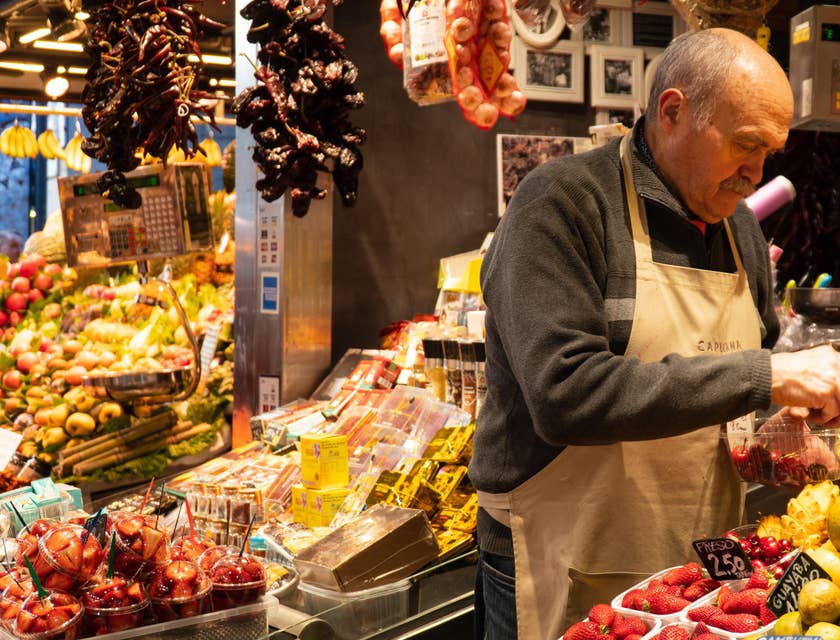 Produce clerk arranging the produce on a transparent container.