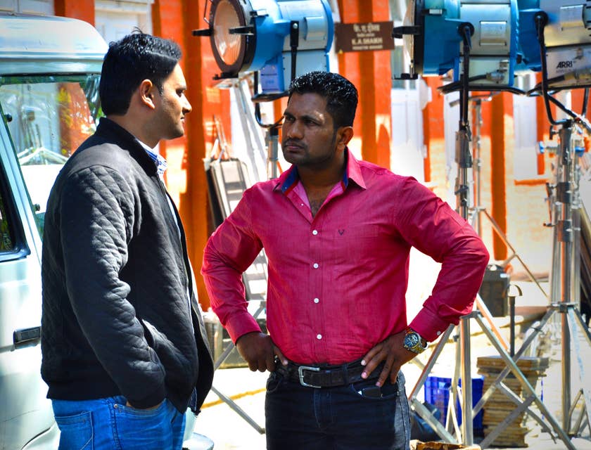 A couple of producers discussing their new project on the set.