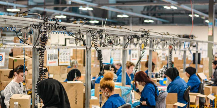 Production Worker assembling the products and packing it into the box for shipment