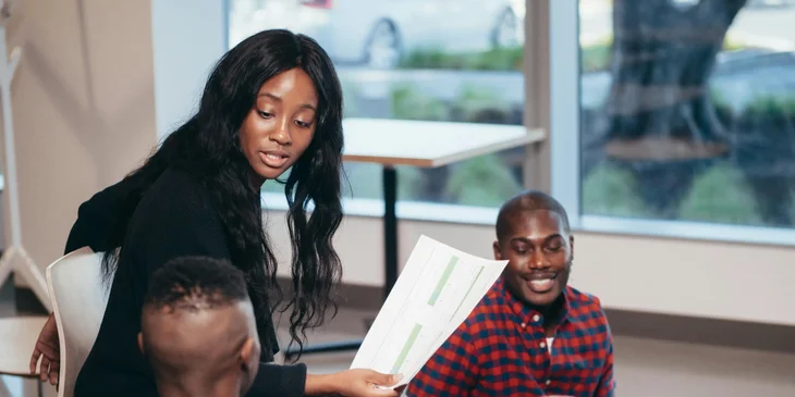 A project specialist in a meeting with her team.