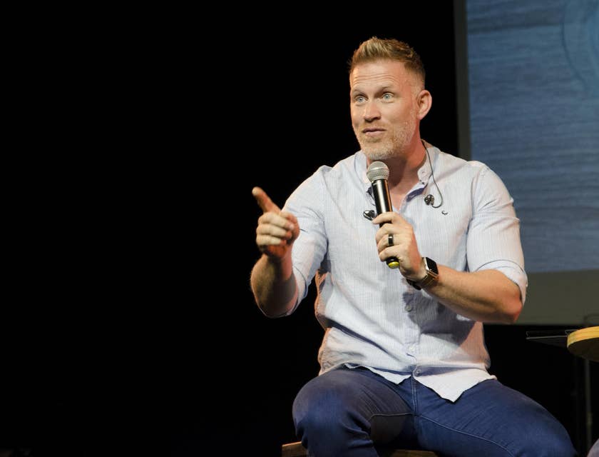 Public speaker interacts with the audience as he discusses a new company and its product
