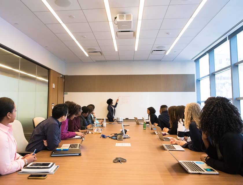 Quality assurance manager training employees to ensure that standards are met.