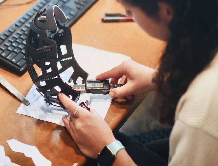 female Quality Engineer checking the size of the new product