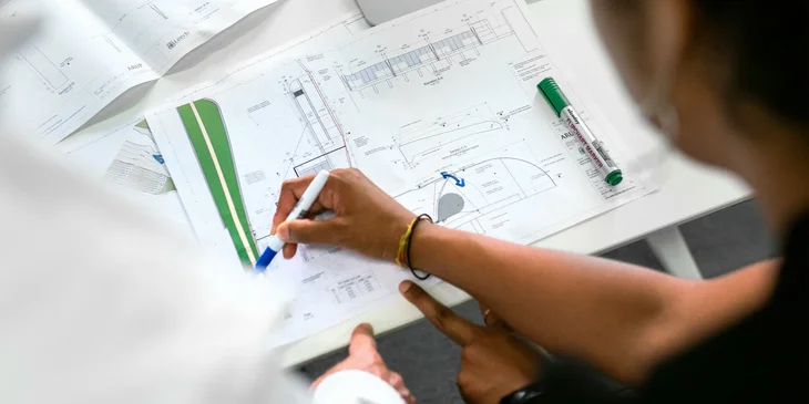 A quantity surveyor discussing an estimated cost for a construction project.