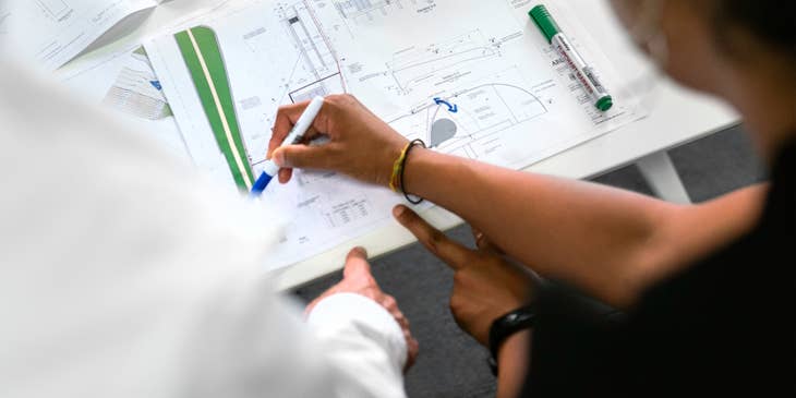 Quantity surveyor discussing the estimated cost for the construction project.