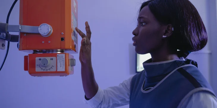 A radiology technician operating a machine.