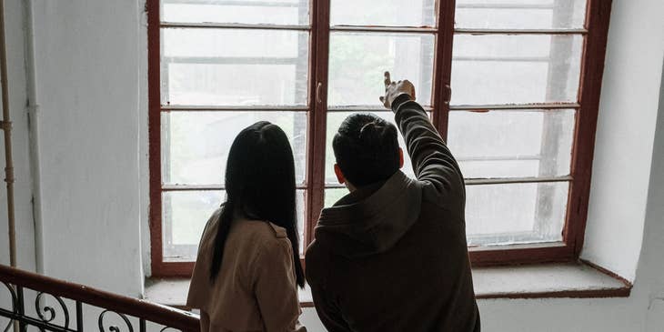 Real Estate Manager with his assistant pointing on various parts of the property that needs repair or improvement