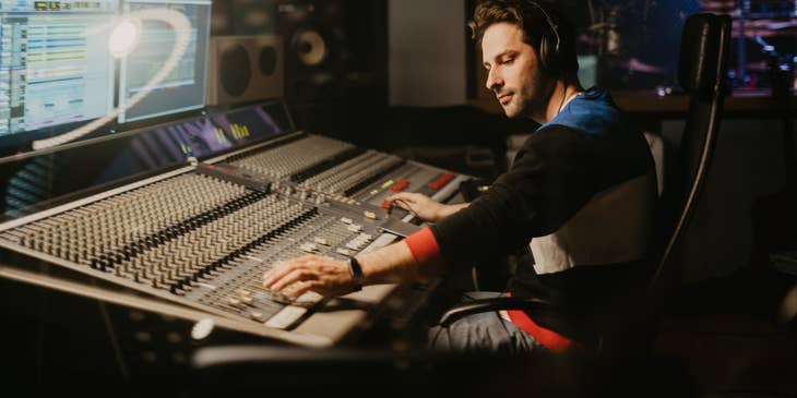 Record producer working overtime arranging their band's new album