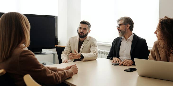 Recruitment marketer along with the HR and marketing lead in the middle of interviewing a candidate