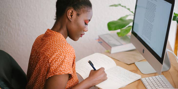 Woman sitting by computer and working.