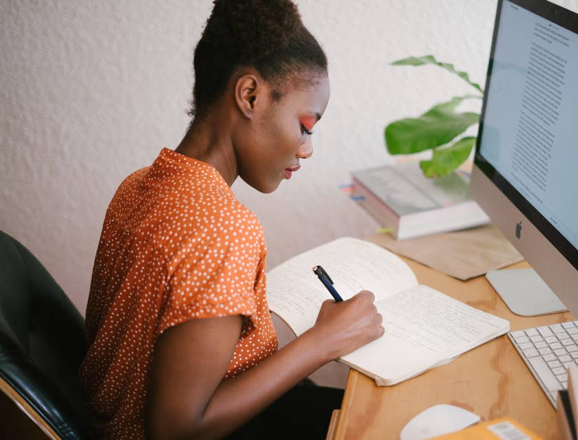 Woman sitting by computer and working.