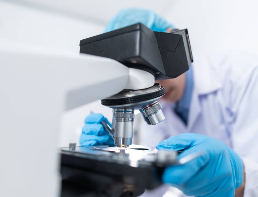 R&D Engineer putting specimen on a microscope for research purposes