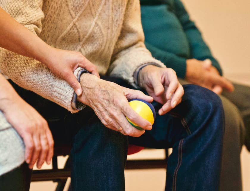 Residential Counselor holding the hand of one of the residents while sitting on a bench