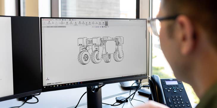 Robotics engineer finalizing his design on his workstation