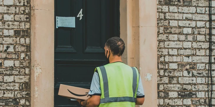 A route driver delivering a package to a client.