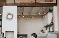 A woman on sabatical leave typing on the floor.