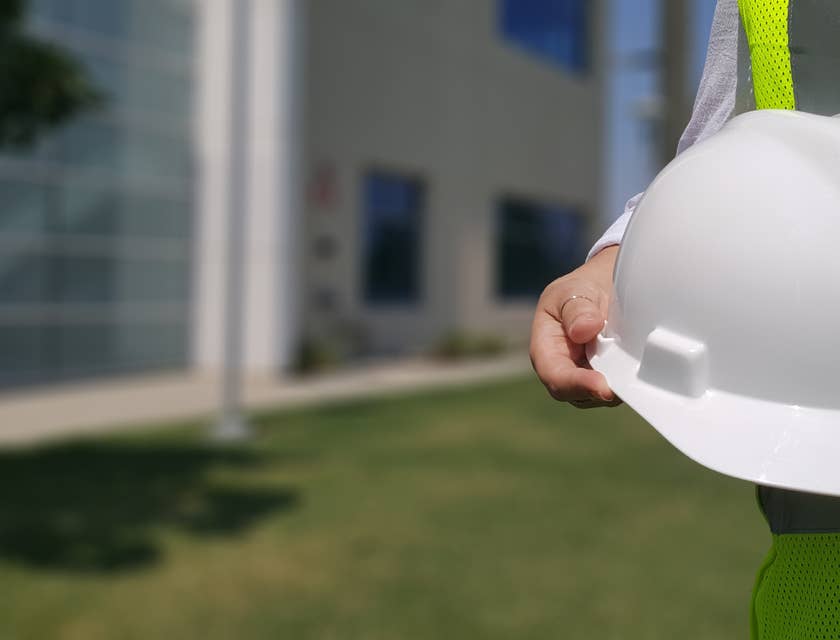 Safety Officer holding his safety hat on his way to ensure workers are practicing safety measures.