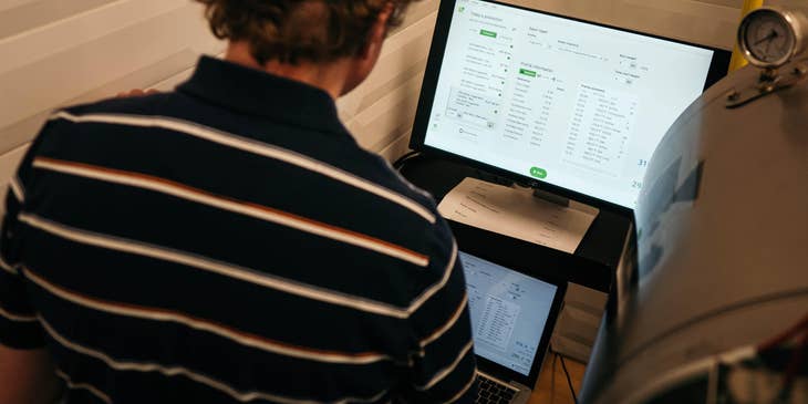 Sales analyst compiling and analyzing sales data in preparation for the report