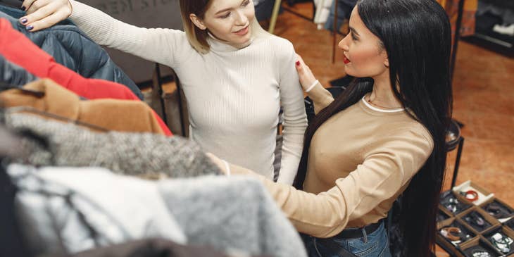 Sales assistant answering client's questions about the clothes she wanted to buy.
