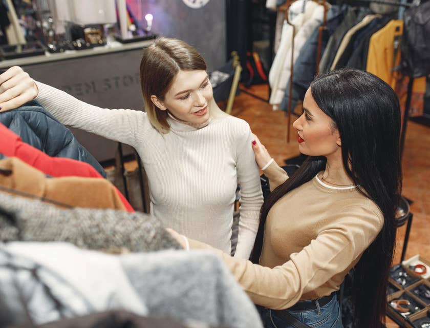 Sales assistant answering client's questions about the clothes she wanted to buy.