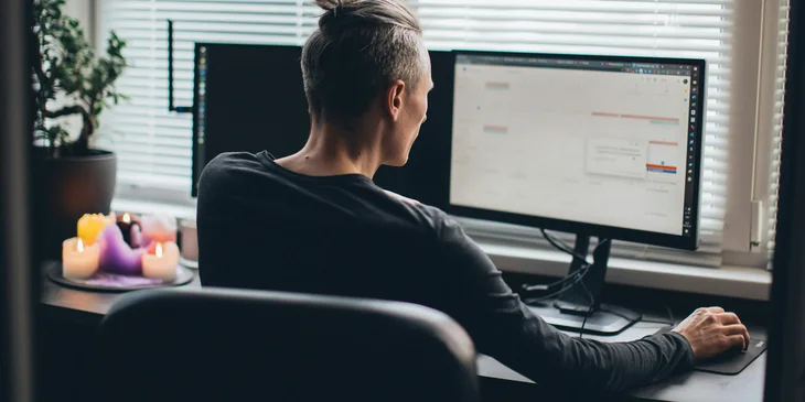 A salesforce developer designing a new application on his desktop computer.