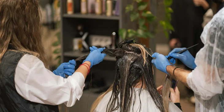 A salon manager supervising a salon worker.