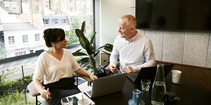 female SAP consultant discussing the customizations needed for the business' process to her client