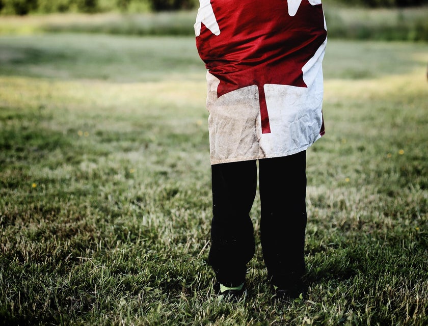 A Canadian child wearing a robe with a Canadian flag.