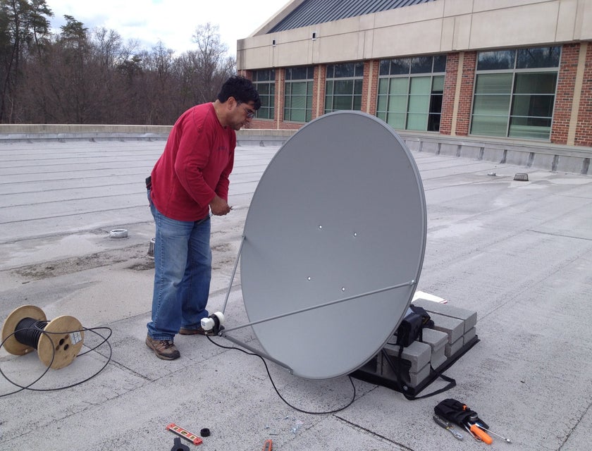 Satellite Technician repairing a satellite dish